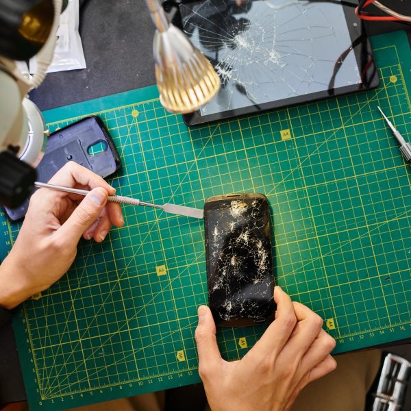 cropped-view-of-repairman-removing-broken-touchscr-2024-11-15-21-32-33-utc